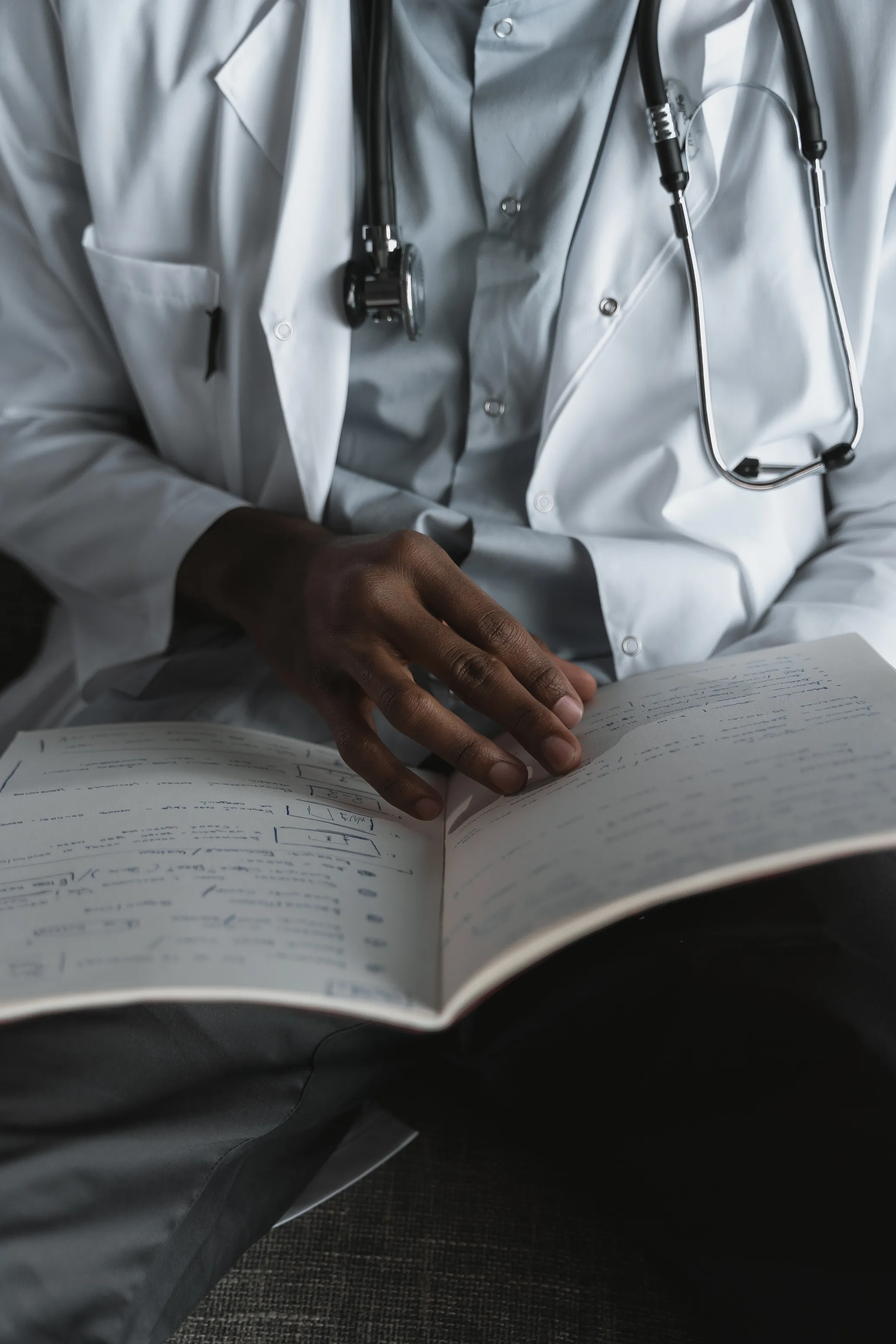 Physician searching through hand-written notes